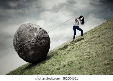 Girl pulling a boulder up a mountain using a thin rope in dark and gloomy weather
