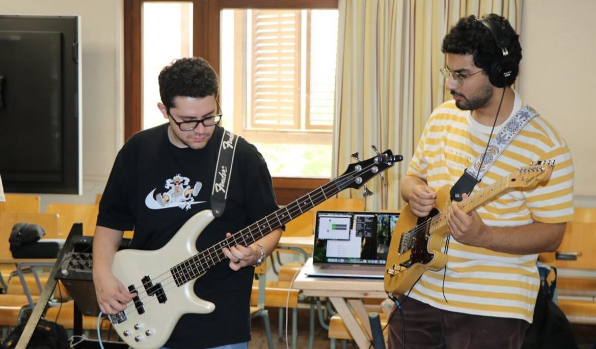 Omar Ayoub playing guitar with his friend