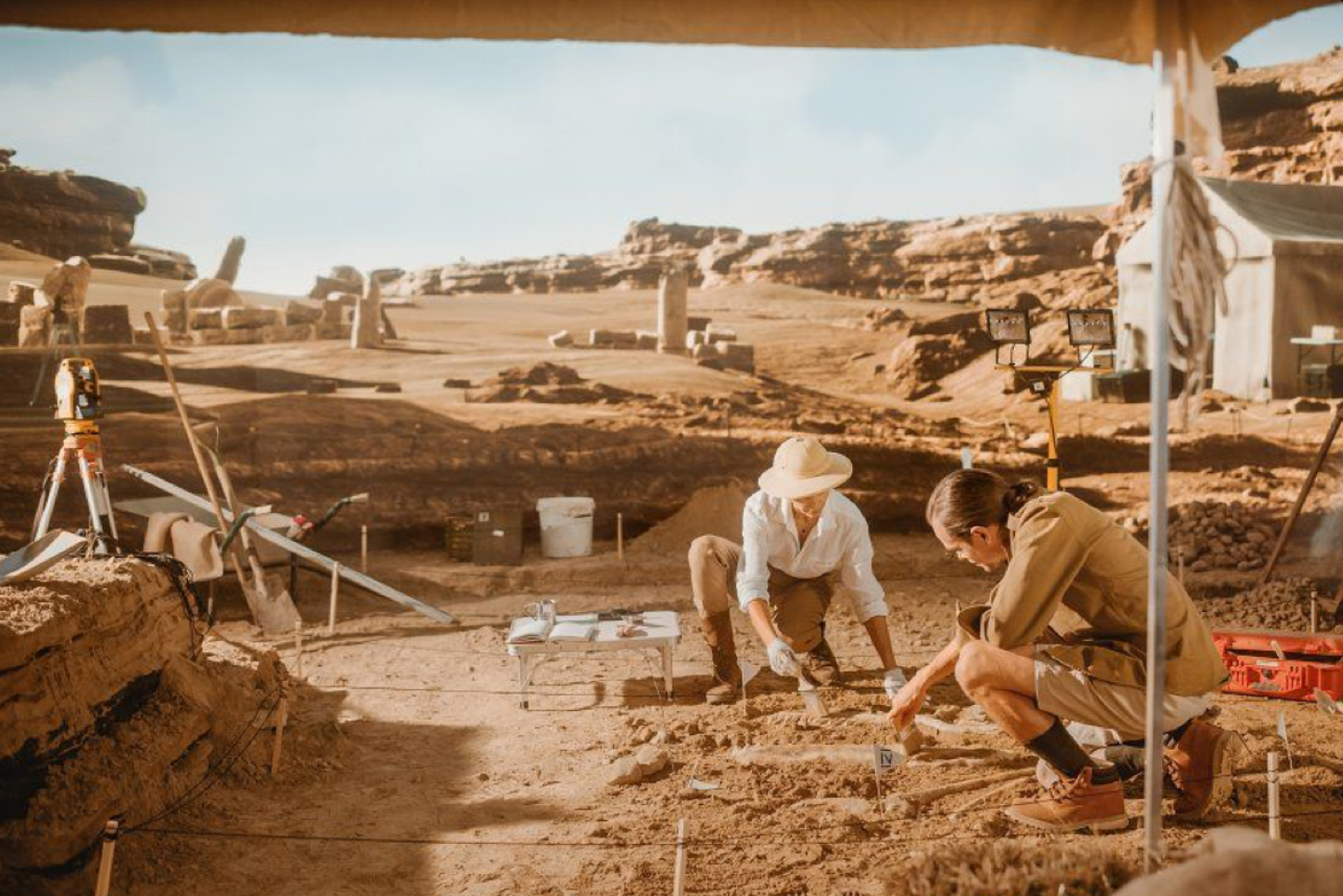 Archaeological excavation site with tools and ancient artifacts